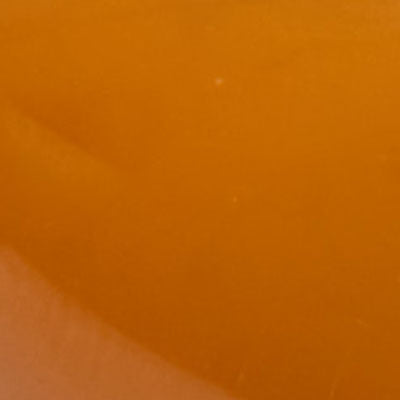 Close-up of a smooth NZ orange surface with a slight gradient and subtle texture.