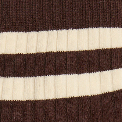 Close-up of NZ-inspired brown ribbed fabric with two horizontal cream-colored stripes.