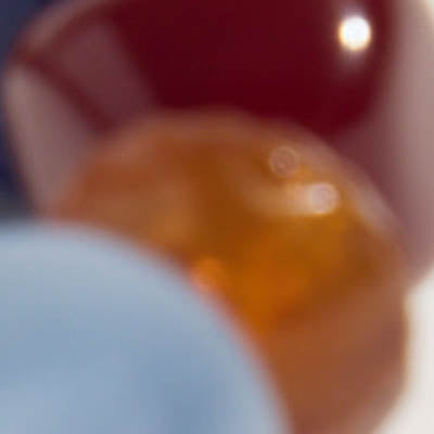 Blurry NZ image with red, orange, and blue shapes blending together.