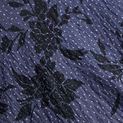 Dark NZ floral pattern on blue fabric with small white polka dots.
