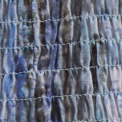 Close-up of blue and gray ruched NZ fabric with horizontal stitching rows.
