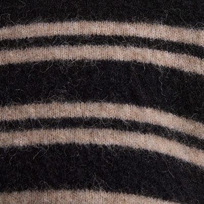 Close-up of fuzzy NZ fabric with black and beige horizontal stripes.