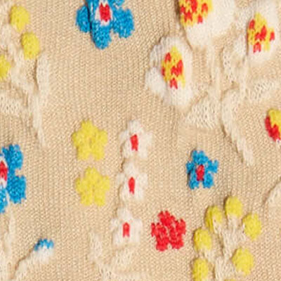 Beige NZ fabric with embroidered red, blue, and yellow floral patterns.